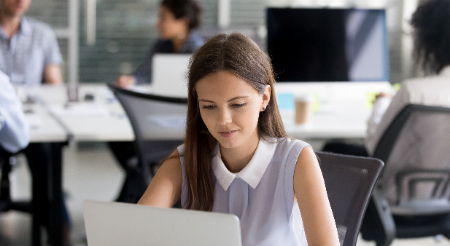 Female student in writing class working on a computer 